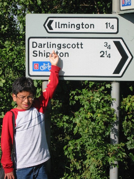 Image of Scott pointing 
at sign for Darlingscott